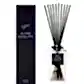 A rectangular Sohum Fragrance Diffuser bottle with natural fiber reeds stands out beside a matching black box labeled "Flowers on Norton St." Both showcase a minimalist and elegant design with white text on a dark background, providing an exquisite fragrance experience.