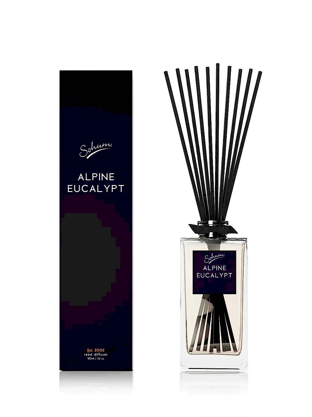 A rectangular Sohum Fragrance Diffuser bottle with natural fiber reeds stands out beside a matching black box labeled "Flowers on Norton St." Both showcase a minimalist and elegant design with white text on a dark background, providing an exquisite fragrance experience.