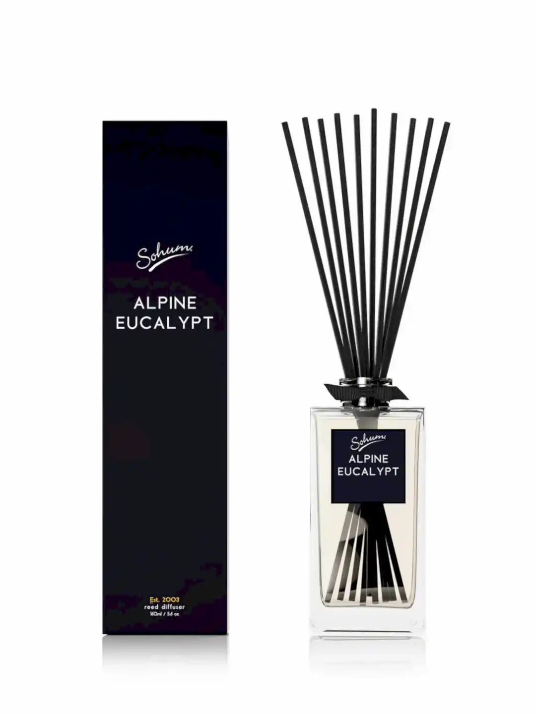 A rectangular Sohum Fragrance Diffuser bottle with natural fiber reeds stands out beside a matching black box labeled "Flowers on Norton St." Both showcase a minimalist and elegant design with white text on a dark background, providing an exquisite fragrance experience.