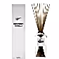 A Sohum Fragrance Diffuser by Flowers on Norton St, a fine fragrance marvel, sits elegantly next to its packaging. The clear glass bottle contains scented liquid with natural fibre reeds protruding from the top. Both the minimalist packaging and bottle feature sleek black text.