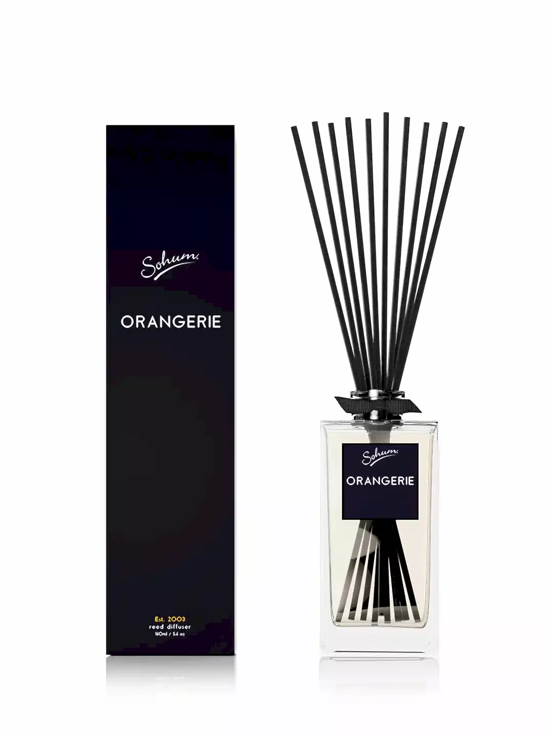 A stylish black bottle of the Sohum Fragrance Diffuser, by Flowers on Norton St, featuring a fine fragrance, is displayed alongside its matching rectangular box. Both showcase sleek black labels. Natural fibre reeds elegantly fan out from the top of the bottle, enhancing its sophisticated allure.