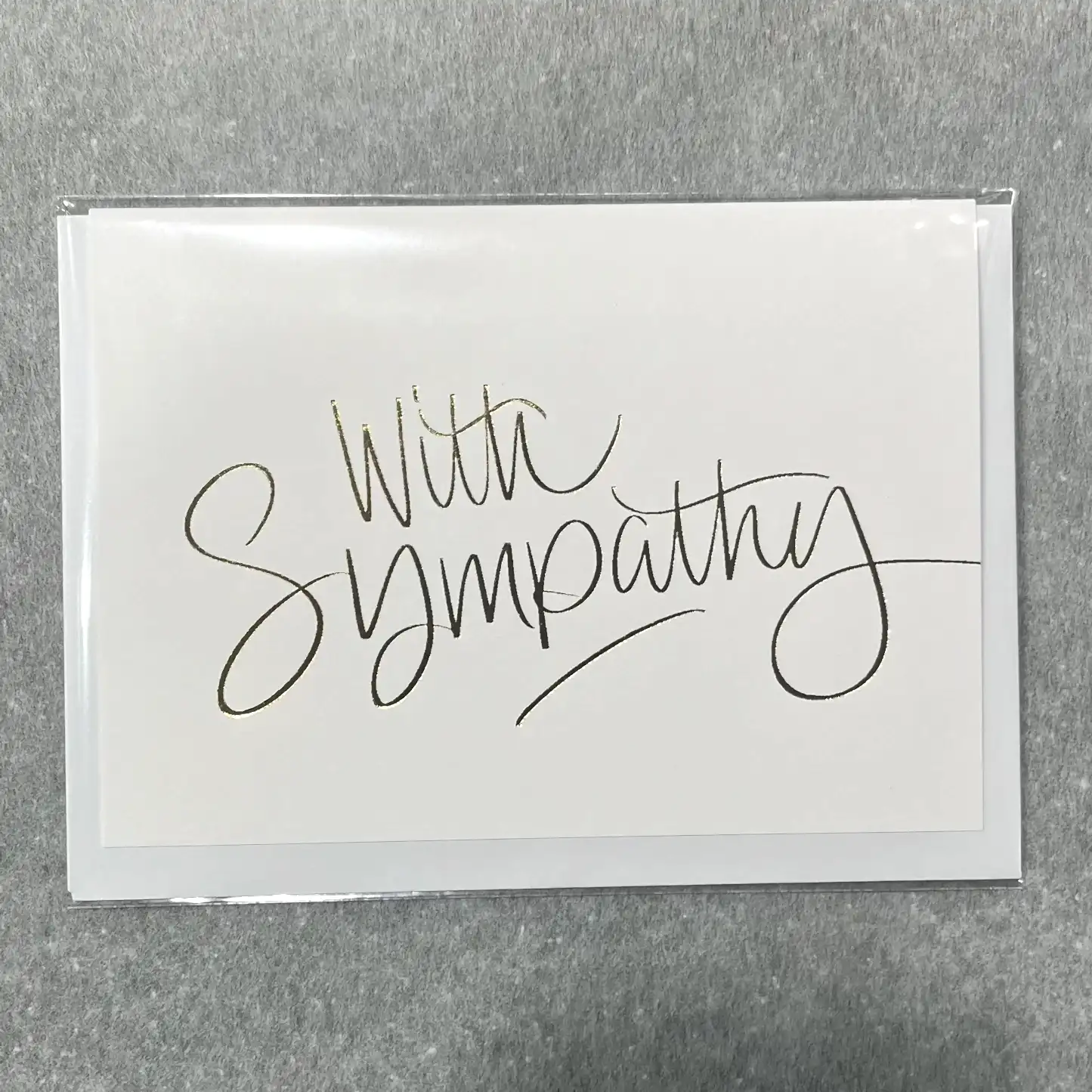 A unique sympathy card from Flowers on Norton St features "With Sympathy" elegantly scripted on the cover, providing a simple yet heartfelt gesture.