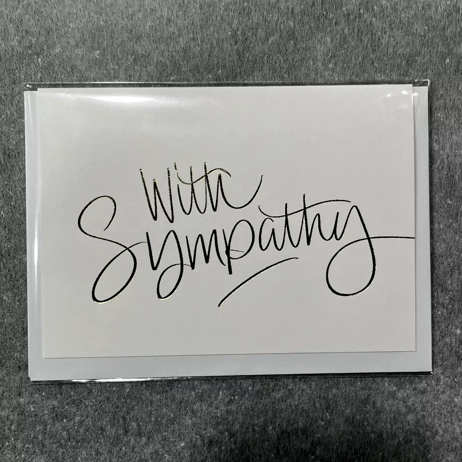 A unique sympathy card from Flowers on Norton St features "With Sympathy" elegantly scripted on the cover, providing a simple yet heartfelt gesture.