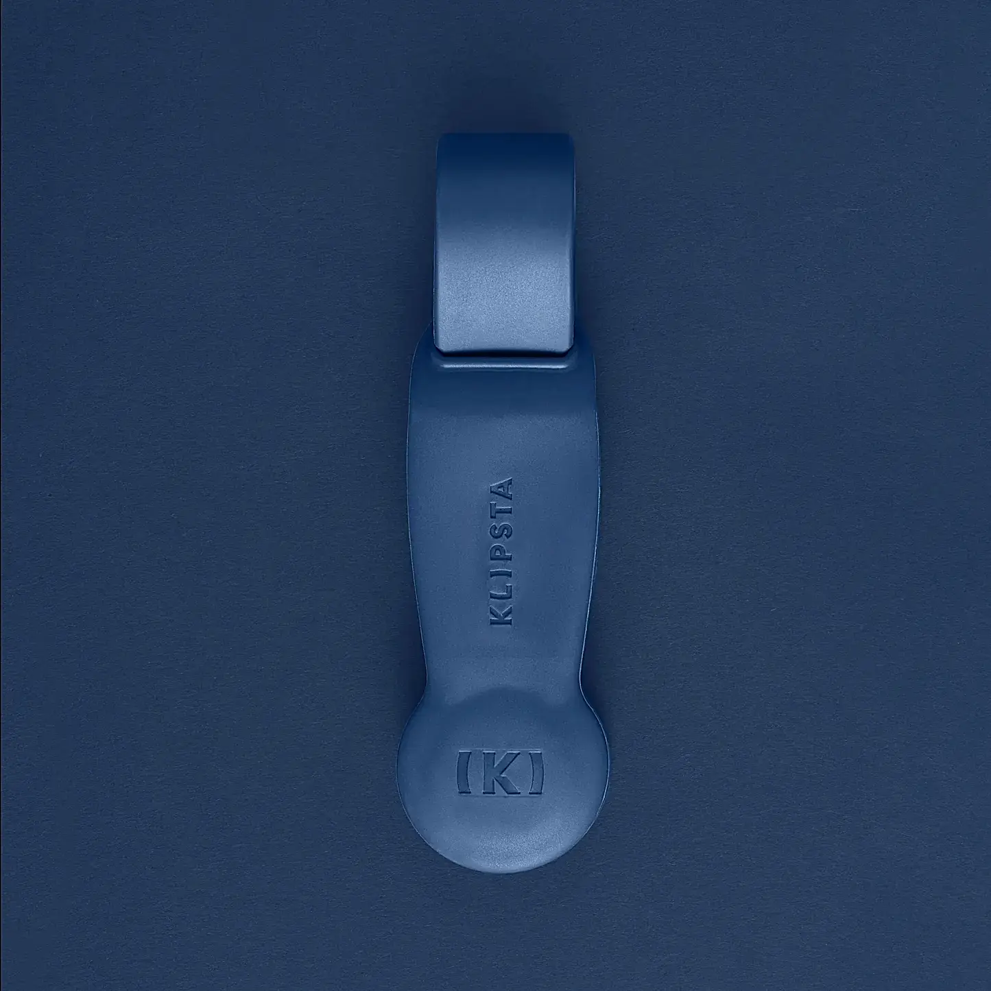 A blue Accessories by Klipsta item from Flowers on Norton St subtly rests on a matching blue surface, hinting at an elegant unity rarely achieved by ordinary glasses clips.