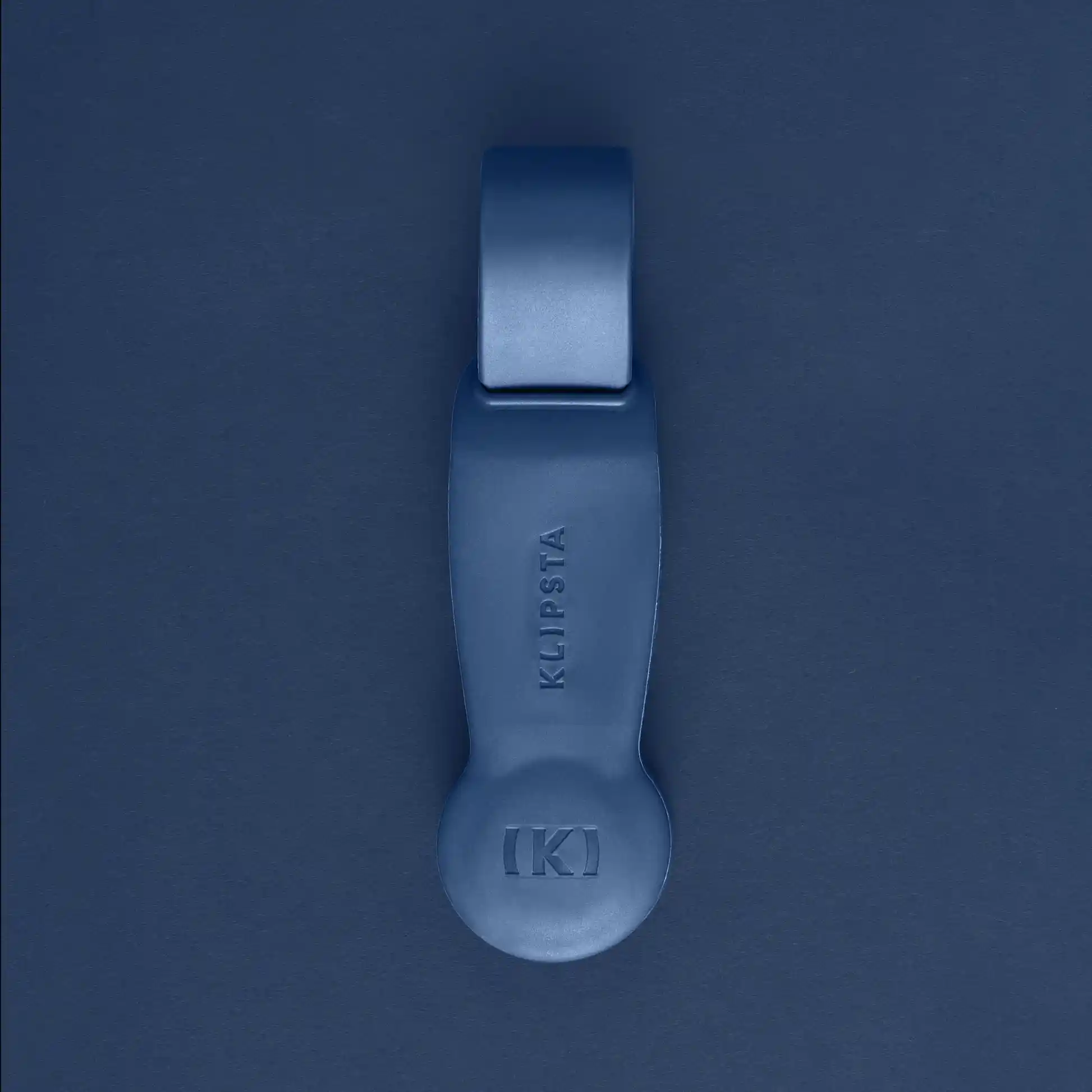 A blue Accessories by Klipsta item from Flowers on Norton St subtly rests on a matching blue surface, hinting at an elegant unity rarely achieved by ordinary glasses clips.