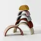 A beloved item from Nordic Kids, the Silicone Rainbow Stacker Toy by Flowers on Norton St features five vibrant, arch-shaped blocks. Crafted from non-toxic silicone, the blocks come in yellow, pink, gray, orange, and cream hues and are beautifully balanced in descending size order against a crisp white background.