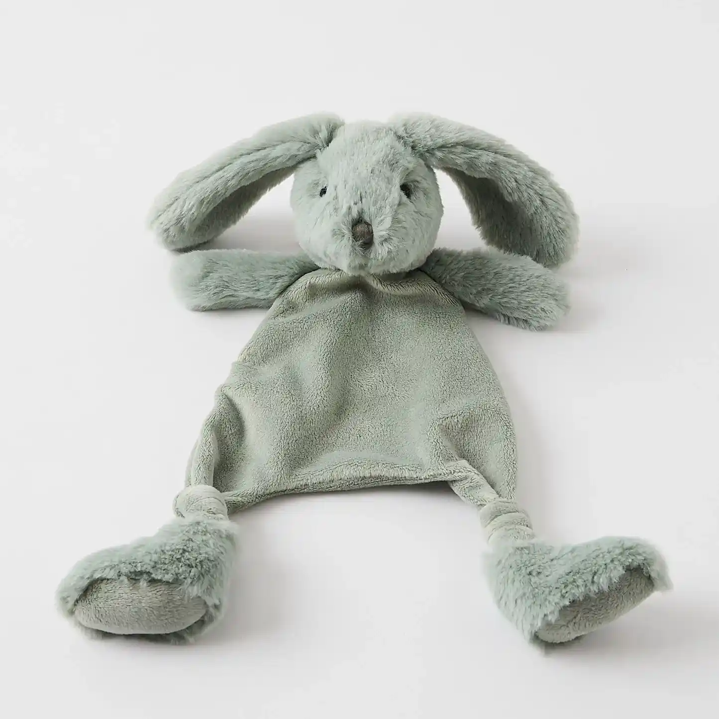The Jiggle & Giggle Bunny Comforter by FlowersonNortonSt, a green rabbit plush toy with ultra-soft fabrics and floppy ears, is ideal for soothing teething babies. Its minimalist design is complemented by its ability to lie flat on a white surface.