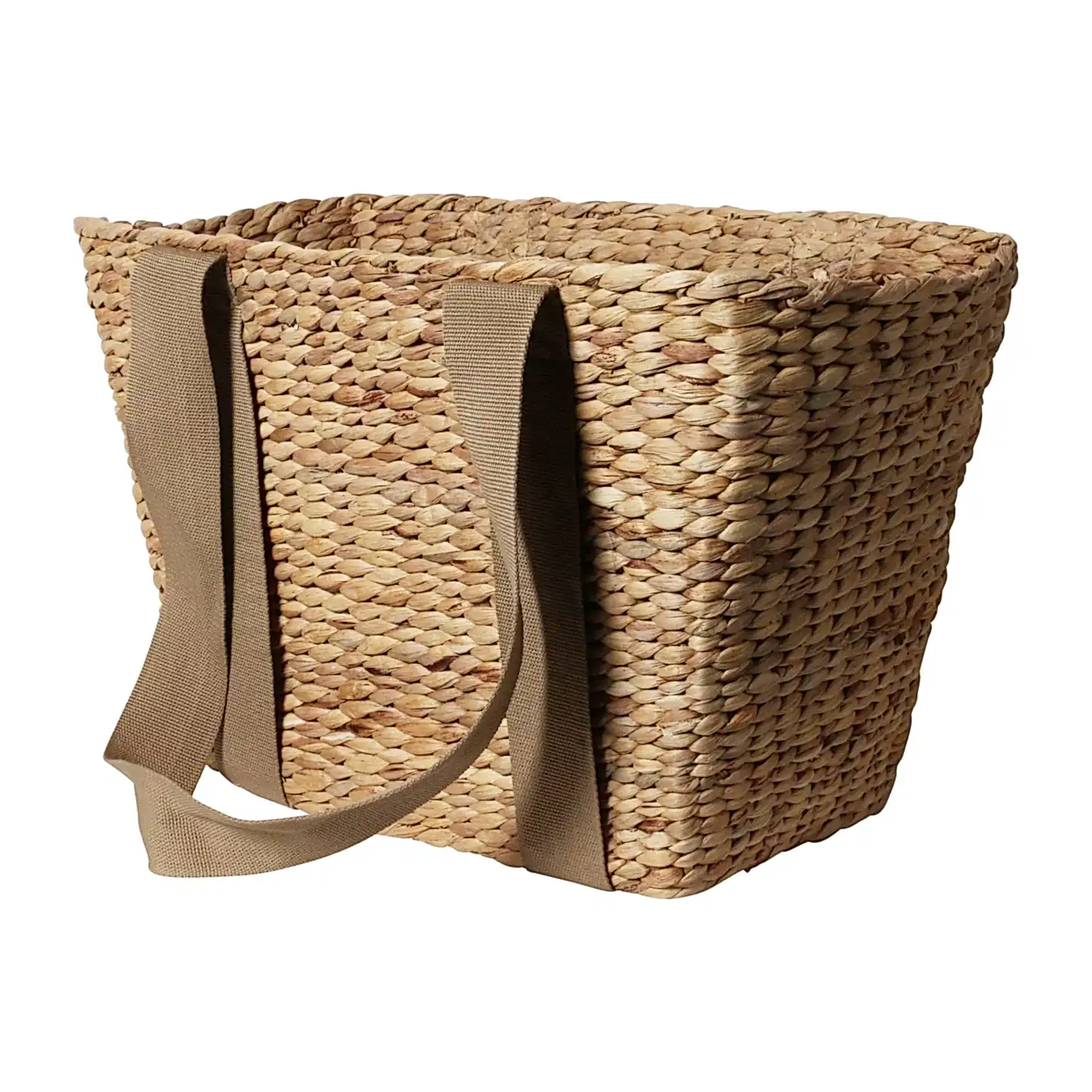 The Journey Tote Bag by Flowers on Norton St is a hand-woven straw tote that features two brown fabric handles and a natural, textured pattern akin to a Water Hyacinth Basket. Its rectangular shape and open top make it ideal for carrying various items.