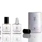 Displayed against a white background are two items from Flowers on Norton St: a perfume bottle with a black cap and another being The Perfume Oil Roll-On, which features a rollerball top. Additionally, there is a compact cylindrical container that prominently declares "Melbourne Australia" as its origin.