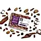 A package of Whisk & Pin Milk Rocky Road by Flowers on Norton St is nestled among almonds, festive Christmas chocolate pieces, blueberries, and marshmallow chunks. The packaging proudly displays its product information and branding.