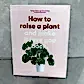 The "How to Raise a Plant | Gift Book" by Flowers on Norton St offers essential plant care advice. It features a potted monstera on a light pink cover, ideal for aspiring indoor gardeners and plant enthusiasts.