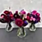 A delightful table centerpiece featuring a group of seasonal blooms elegantly arranged in Lovely Vintage Vases by FlowersonNortonSt from Australia.