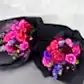 The Hot Pink Pop Mixed Flower Bouquet by Flowers on Norton St features two elegant floral arrangements wrapped in black paper. Each bouquet showcases a vibrant mix of fuchsia, pink, and purple flowers, including roses and dahlias, artfully crafted from seasonal blooms against a light gray background.