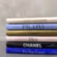 A stack of "Little Book of Style" books by Flowers on Norton St, ideal for the fashion enthusiast. From top to bottom: Louis Vuitton, Prada, Gucci, Dior, Chanel, and Yves Saint Laurent. These minimalist covers honor legendary fashion houses against a sophisticated neutral backdrop.