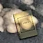 A book titled "Little Book of Style" by Flowers on Norton St rests on a sunlit concrete surface, casting soft, dappled shadows around it. Perfect for the fashion lover, this gold-covered gem in the "Flowers on Norton St" collection boasts a simple, elegant design worthy of top fashion houses.
