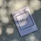 A copy of *Little Book of Style* from Flowers on Norton St is on the ground, ideal for any fashion enthusiast interested in iconic fashion houses.