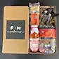 The "Pasta for Two Gift Box" by Flowers on Norton St includes spaghetti, tortiglioni, vodka tomato sauce, and two small olive oil bottles. The lid is adorned with "F+N gifting," and the items are elegantly arranged with protective shredded paper for a delightful gifting experience.