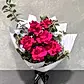 The Only Roses Bouquet from Flowers on Norton St features vibrant Colombian roses with lush green leaves, elegantly wrapped in white paper and tied with a black ribbon. Set against a light gray textured background, it's perfect for expressing heartfelt sentiments.