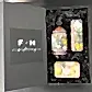 Introducing the Royal Botanical Gardens Fragrance Collection by Flowers on Norton St. This elegant gift box includes a magnolia and pear hand wash, a complementary hand cream, and a scented soap. Each item is nestled in black shredded paper within a sleek black box labeled "F + N gifting." Enjoy the luxury of same-day delivery with this exquisite set, inspired by the beauty of the Royal Botanical Gardens.