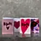A set of four Mother's Day greeting cards from Flowers on Norton St is displayed against a textured background. Ideal for Sydney mums, these cards are decorated with heart motifs and messages such as "Mum" and "Happy Mother's Day," all embellished with pink, red, and floral designs reminiscent of top flower delivery choices.