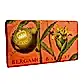 A rectangular soap bar with a vibrant orange wrapper from the KEW Soap range by Flowers on Norton St, featuring illustrations of bergamot and ginger plants. The packaging prominently showcases the Kew Royal Botanical Gardens logo and the text "Bergamot & Ginger.