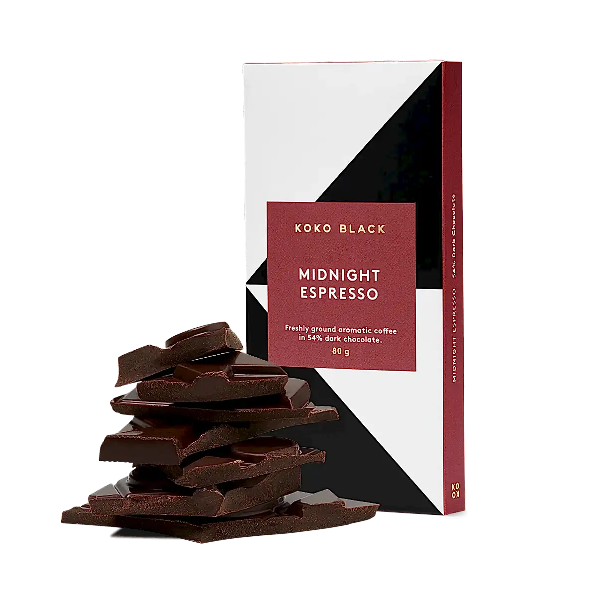 A FlowersonNortonSt Koko Black Chocolate Block stands upright. Next to it, a stack of dark chocolate pieces is arranged. The maroon and white packaging reveals a handcrafted delight, combining freshly ground aromatic coffee with 54% dark chocolate made from sustainably sourced cocoa.