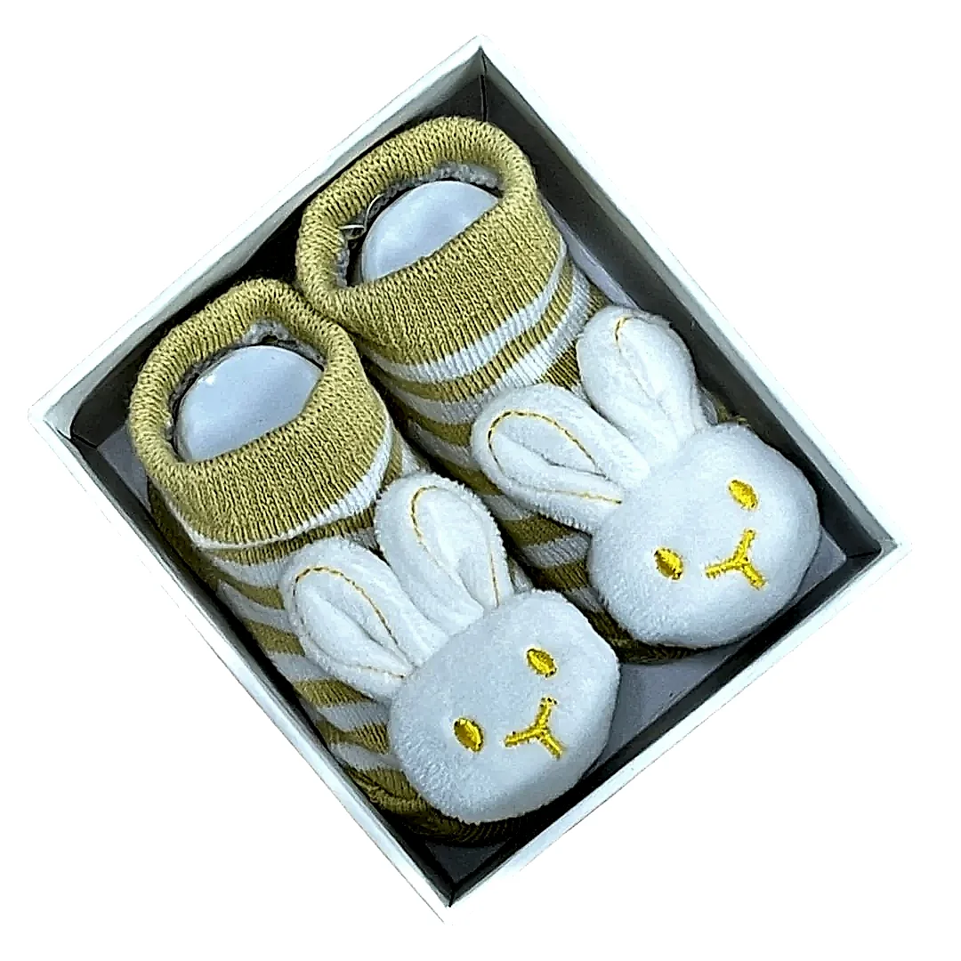 Tucked inside a box, the Baby Bunny Socks from Flowers on Norton St exude cuteness with their yellow and white stripes and plush white bunny faces showcasing embroidered yellow eyes and noses.