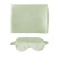A Satin Sleep Set from Flowers on Norton St features a light green silk sleep mask with an adjustable strap, accompanied by a matching folded satin pillowcase. The smooth, shiny fabric suggests a soft texture perfect for wrinkle prevention.