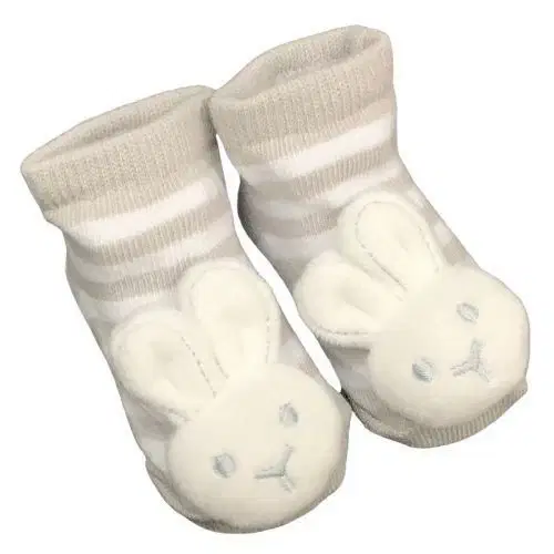 The delightful Baby Bunny Socks by Flowers on Norton St boast beige and white stripes, adorned with a cute plush bunny face featuring embroidered eyes and nose at the front. Equipped with built-in rattles, they create a cheerful jingle with every tiny step.