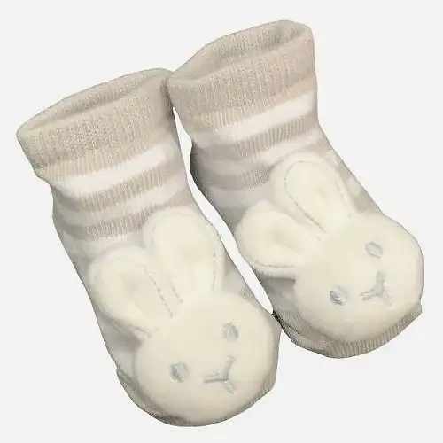 The delightful Baby Bunny Socks by Flowers on Norton St boast beige and white stripes, adorned with a cute plush bunny face featuring embroidered eyes and nose at the front. Equipped with built-in rattles, they create a cheerful jingle with every tiny step.