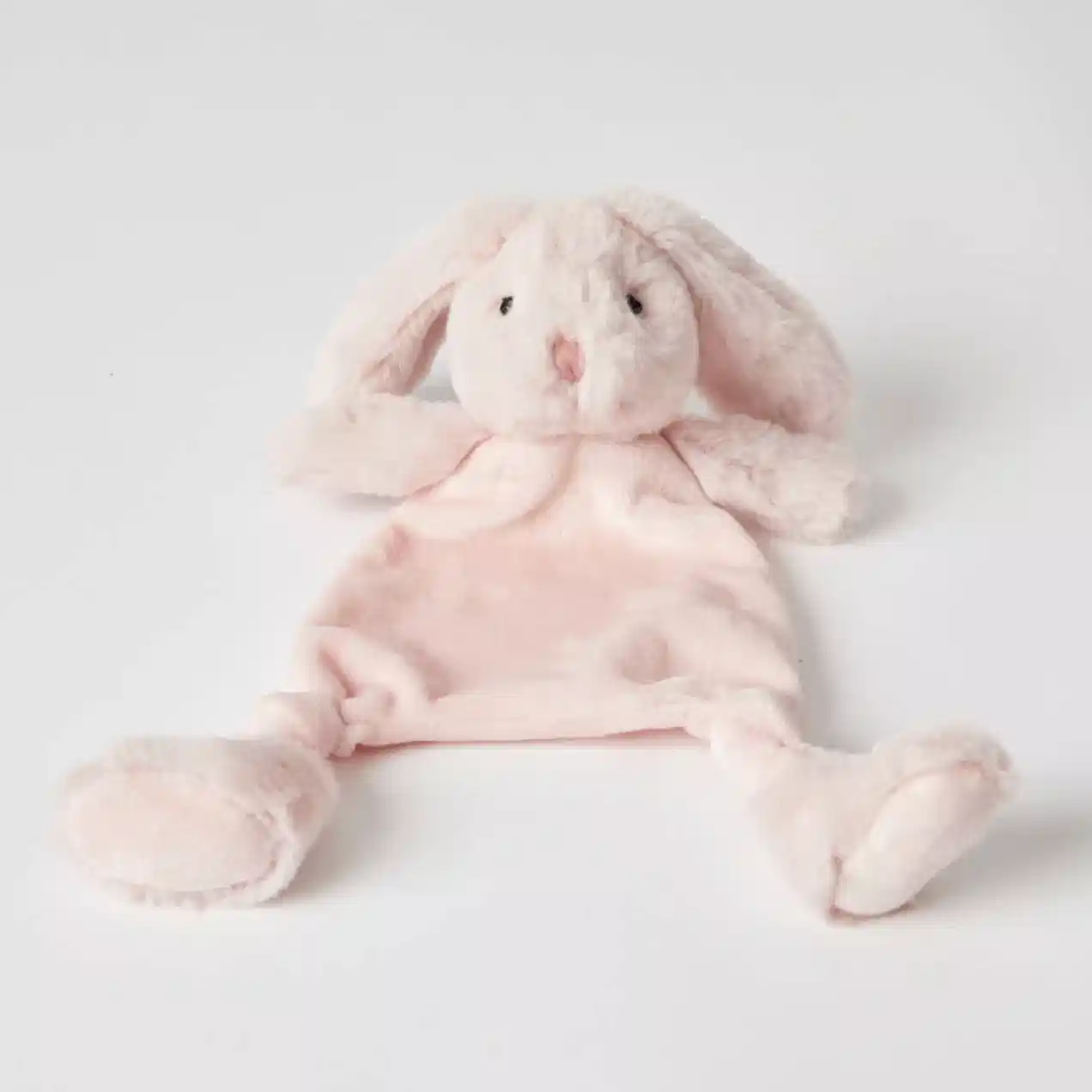 The Jiggle & Giggle Bunny Comforter by FlowersonNortonSt is a plush pink toy made from ultra-soft fabrics, designed with floppy ears and a simple embroidered face. It lies against a white background and is ideal for teething babies, featuring a flat body and rounded feet to provide both comfort and companionship.