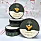 Three containers of the "We The Wild Plant Care Products" by FlowersonNortonSt, labeled "support," are stacked against a marbled background. Perfect for indoor plants, each dark green container features a stylized plant logo and text indicating it's a bioactive food to nurture your potted plants.