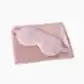A Satin Sleep Set from Flowers on Norton St features a pink silk sleep mask resting on a matching satin pillowcase, elegantly designed to prevent wrinkles.