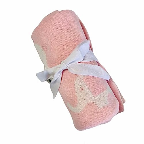 An adorable, rolled-up Ellie Baby Blanket by FlowersonNortonSt, featuring soft white elephant patterns on a pink background and elegantly tied with a delicate white ribbon.