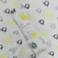 A FlowersonNortonSt Muslin Wrap features a delightful pattern of yellow, gray, and black elephants. The packaging label states, "Muslin Wraps, 100% Cotton, 120x120cm." Ideal for baby swaddling, it is set against matching elephant-patterned fabric.