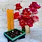 The Veuve Surprise by Flowers on Norton St features a striking bouquet of red and pink roses in a gleaming gold pot alongside a Veuve Clicquot Champagne box. Completing the ensemble is an open turquoise box of assorted chocolates, all beautifully set against a marble background.