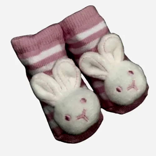 Introducing the adorable Baby Bunny Socks by Flowers on Norton St, featuring a lovely pink and white striped design with plush bunny faces on top. These charming socks also include hidden rattles to keep your little one entertained.